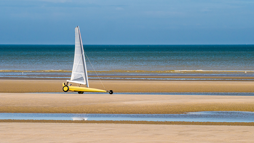 photo of a sand yacht at low tide